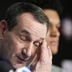 
              Duke head coach Mike Krzyzewski wipes his face during a news conference after Duke's loss against North Carolina during a college basketball game in the semifinal round of the Men's Final Four NCAA tournament, Saturday, April 2, 2022, in New Orleans. (AP Photo/David J. Phillip)
            