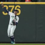 Seattle Mariners center fielder Julio Rodriguez returns the ball after he made a diving catch of a fly ball hit by Houston Astros' Michael Brantley during the fifth inning of a baseball game, Saturday, April 16, 2022, in Seattle. (AP Photo/Ted S. Warren)