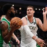 
              Boston Celtics' Jaylen Brown grabs the ball in front of Milwaukee Bucks' Brook Lopez during the first half of an NBA basketball game Thursday, April 7, 2022, in Milwaukee. (AP Photo/Morry Gash)
            