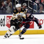 
              Boston Bruins forward David Pastrnak, left, controls the puck in front of Columbus Blue Jackets defenseman Jake Bean during the second period of an NHL hockey game in Columbus, Ohio, Monday, April 4, 2022. (AP Photo/Paul Vernon)
            