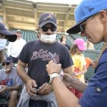 
              Tampa Tarpons manager Rachel Balkovec, right, signs autographs for fans, while making her debut as a minor league manager of the Tarpons, a Single-A affiliate of the New York Yankees, before a baseball game against the Lakeland Flying Tigers, Friday, April 8, 2022, in Lakeland, Fla. Balkovic is the first female to manage a professional baseball team. (AP Photo/Phelan M. Ebenhack)
            