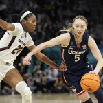 
              UConn's Paige Bueckers tries to get past South Carolina's Bree Hall during the first half of a college basketball game in the final round of the Women's Final Four NCAA tournament Sunday, April 3, 2022, in Minneapolis. (AP Photo/Eric Gay)
            
