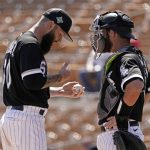 
              Chicago White Sox's Dallas Keuchel, left, and catcher Nick Ciuffo meet on the mound during the third inning of a spring training baseball game against the Oakland Athletics Friday, April 1, 2022, in Glendale, Ariz. (AP Photo/Charlie Riedel)
            