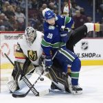 
              Vancouver Canucks' Alex Chiasson (39) is checked by Vegas Golden Knights' Shea Theodore, back, as he tries to redirect the puck in front of goalie Robin Lehner, left, during the third period of an NHL hockey game Sunday, April 3, 2022, in Vancouver, British Columbia. (Darryl Dyck/The Canadian Press via AP)
            