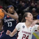 
              UConn's Christyn Williams grabs a rebound in front of Stanford's Lacie Hull during the second half of a college basketball game in the semifinal round of the Women's Final Four NCAA tournament Friday, April 1, 2022, in Minneapolis. (AP Photo/Charlie Neibergall)
            