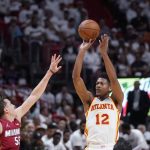 
              Atlanta Hawks forward De'Andre Hunter (12) takes a shot against Miami Heat forward Duncan Robinson (55) during the first half of Game 5 of an NBA basketball first-round playoff series, Tuesday, April 26, 2022, in Miami. (AP Photo/Wilfredo Lee)
            