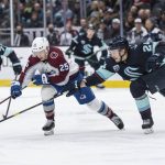 
              Seattle Kraken defenseman Jamie Oleksiak, right, attempts to knock the puck away from Colorado Avalanche forward Logan O'Connor during the first period of an NHL hockey game Wednesday, April 20, 2022, in Seattle. (AP Photo/Stephen Brashear)
            