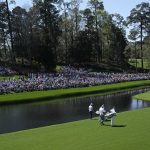 
              Cameron Smith, of Australia, and Bryson DeChambeau, right, walk along the 16th fairway with their caddies during the first round at the Masters golf tournament on Thursday, April 7, 2022, in Augusta, Ga. (AP Photo/David J. Phillip)
            