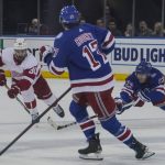 
              Detroit Red Wings center Joe Veleno (90) goes after loose puck against New York Rangers center Kevin Rooney (17) and New York Rangers defenseman Adam Fox (23) during second period of NHL hockey game, Saturday April 16, 2022, in New York. (AP Photo/Bebeto Matthews)
            