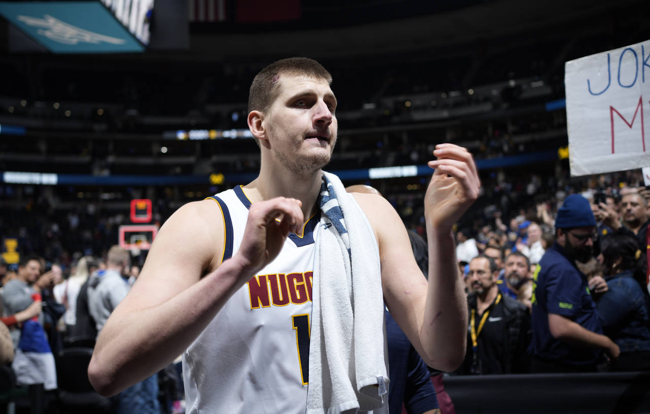 Denver Nuggets center Nikola Jokic heads off the court after the team's NBA basketball game against...