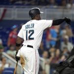 
              Miami Marlins outfielder Jorge Soler (12) guides a scoring run into home plate during the fourth inning of a baseball game, Sunday, April 17, 2022, in Miami. (AP Photo/Mary Holt)
            