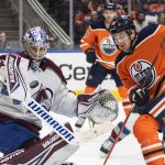 
              Colorado Avalanche goalie Darcy Kuemper (35) makes a save as Edmonton Oilers' Zach Hyman (18) looks for a rebound during second-period NHL hockey game action in Edmonton, Alberta, Friday, April 22, 2022. (Jason Franson/The Canadian Press via AP)
            