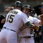 
              Oakland Athletics' Nick Allen (2) is congratulated by Seth Brown (15) after scoring on a single by Tony Kemp against the Baltimore Orioles during the seventh inning of a baseball game in Oakland, Calif., Thursday, April 21, 2022. (AP Photo/Jed Jacobsohn)
            