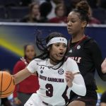 
              South Carolina's Destanni Henderson tries to get past Louisville's Kianna Smith during the first half of a college basketball game in the semifinal round of the Women's Final Four NCAA tournament Friday, April 1, 2022, in Minneapolis. (AP Photo/Charlie Neibergall)
            