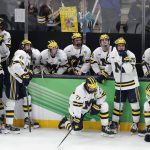 
              Michigan players react after losing to Denver in overtime during an NCAA men's Frozen Four semifinal hockey game, Thursday, April 7, 2022, in Boston. (AP Photo/Michael Dwyer)
            