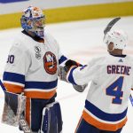 
              New York Islanders goaltender Ilya Sorokin (30) and defenseman Andy Greene (4) celebrate after an NHL hockey game against the Washington Capitals, Tuesday, April 26, 2022, in Washington. The Islanders 4-1. (AP Photo/Nick Wass)
            