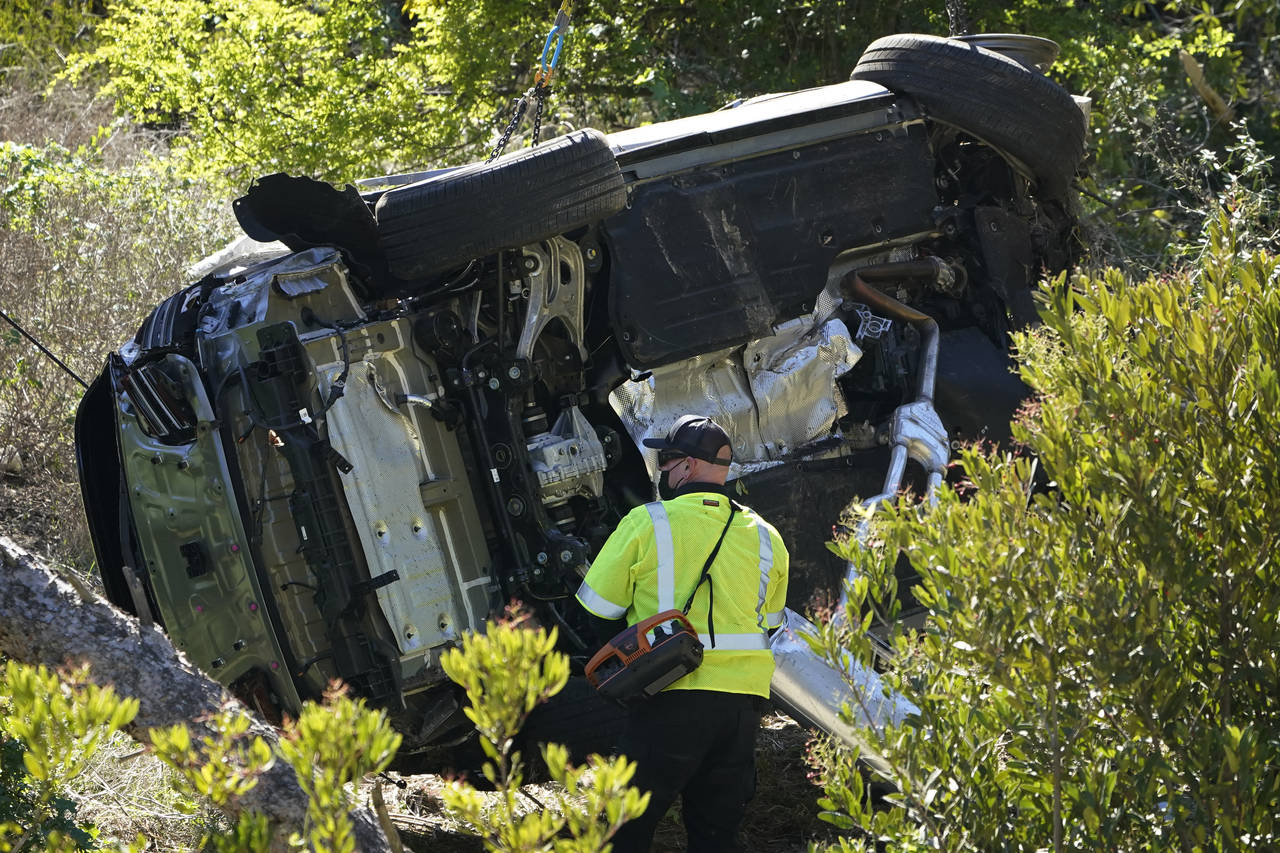 FILE - A vehicle rests on its side after a rollover accident involving golfer Tiger Woods Tuesday, ...