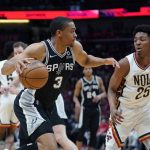 
              San Antonio Spurs forward Keldon Johnson (3) drives to the basket against New Orleans Pelicans guard Trey Murphy III (25) in the first half of an NBA play-in basketball game in New Orleans, Wednesday, April 13, 2022. (AP Photo/Gerald Herbert)
            