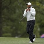 
              Tiger Woods walks down the first fairway during the third round at the Masters golf tournament on Saturday, April 9, 2022, in Augusta, Ga. (AP Photo/David J. Phillip)
            