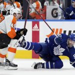 
              Toronto Maple Leafs defenceman Mark Giordano (55) gets hit by Philadelphia Flyers forward Noah Cates (49) during the third period of an NHL hockey game Tuesday, April 19, 2022 in Toronto. (Nathan Denette/The Canadian Press via AP)
            