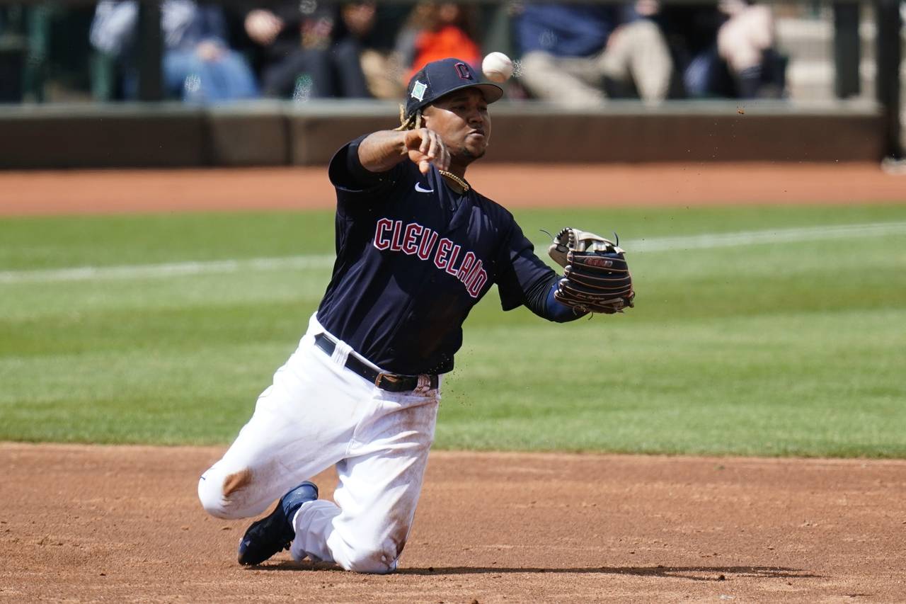 Cleveland Guardians third baseman Jose Ramirez throws from his knees to second base but is unable t...