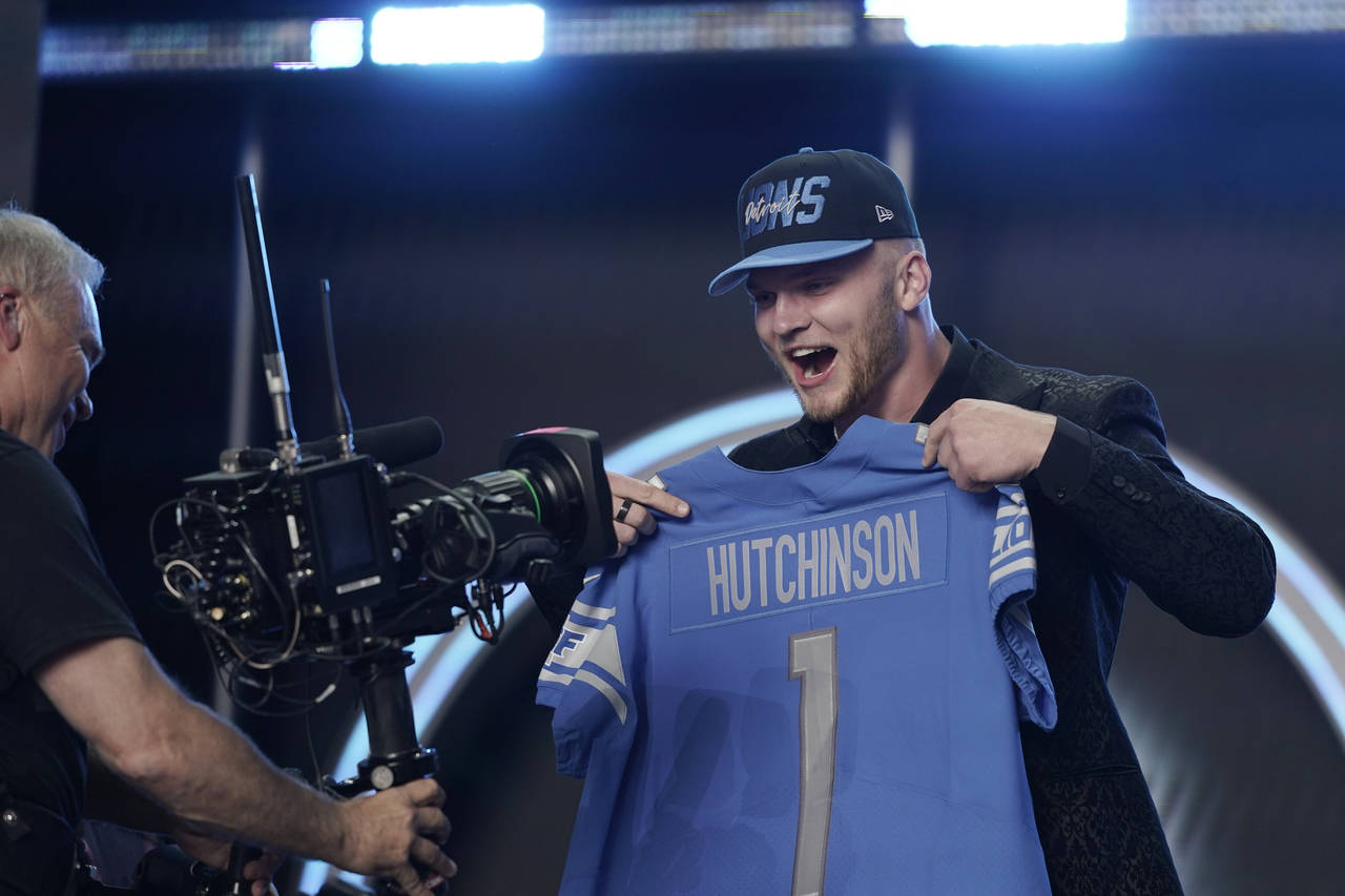 Michigan defensive end Aidan Hutchinson celebrates being selected by the Detroit Lions as the secon...