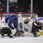 
              Vancouver Canucks' Vasily Podkolzin, second from left, scores against Vegas Golden Knights goalie Robin Lehner during the second period of an NHL hockey game Tuesday, April 12, 2022, in Vancouver, British Columbia. (Darryl Dyck/The Canadian Press via AP)
            