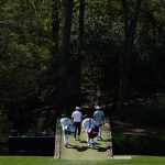 
              Scottie Scheffler and Sam Burns walk over the Ben Hogan Bridge on the 12th fairway during a practice round for the Masters golf tournament on Monday, April 4, 2022, in Augusta, Ga. (AP Photo/Jae C. Hong)
            