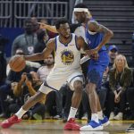 
              Golden State Warriors forward Andrew Wiggins, left, is defended by Denver Nuggets forward Will Barton during the first half of Game 2 of an NBA basketball first-round playoff series in San Francisco, Monday, April 18, 2022. (AP Photo/Jeff Chiu)
            