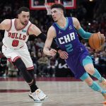 
              Charlotte Hornets guard LaMelo Ball, right, drives as Chicago Bulls guard Zach LaVine guards during the first half of an NBA basketball game in Chicago, Friday, April 8, 2022. (AP Photo/Nam Y. Huh)
            