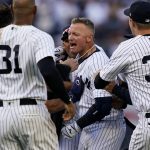 
              CORRECTS TO 11TH INNING, NOT 12TH - New York Yankees' Josh Donaldson, center, celebrates after hitting the walk-off single in the 11th inning of an opening day baseball game against the Boston Red Sox, Friday, April 8, 2022, in New York. (AP Photo/John Minchillo)
            