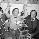 
              FILE - Montreal Canadiens' Guy Lafleur, center, team captain Serge Savard, left, and Yvan Cournoyer celebrate Lafleur's win of the Conn Smythe Most Valuable Player trophy in the team's dressing room after their Stanley Cup victory at Boston Garden in Boston, Ma., May 14, 1977. Hockey Hall of Famer Guy Lafleur, who helped the Montreal Canadiens win five Stanley Cup titles in the 1970s, died Friday, April 22, 2022, at age 70. (AP Photo/File)
            