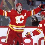 
              Calgary Flames left wing Matthew Tkachuk (19) celebrates his 40th goal and his 100th point of the season with teammate left wing Andrew Mangiapane (88) during second-period NHL hockey game action against the Dallas Stars in Calgary, Alberta, Thursday April 21, 2022. (Larry MacDougal/The Canadian Press via AP)
            