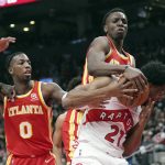 
              Toronto Raptors forward Thaddeus Young (21) battles for the ball against Atlanta Hawks guard Delon Wright (0) and forward Onyeka Okongwu (17) during the first half of an NBA basketball game in Toronto on Tuesday, April 5, 2022. (Nathan Denette/The Canadian Press via AP)
            