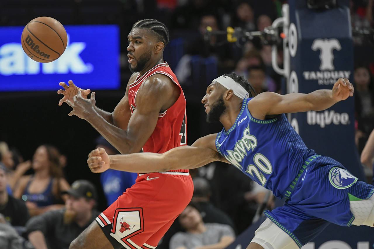Minnesota Timberwolves guard Josh Okogie, right, knocks the ball out of the hands of Chicago Bulls ...