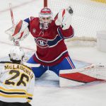 
              Montreal Canadiens goaltender Sam Montembeault, top, makes a save against Boston Bruins' Marc McLaughlin, bottom, during third-period NHL hockey game action in Montreal, Sunday, April 24, 2022. (Graham Hughes/The Canadian Press via AP)
            