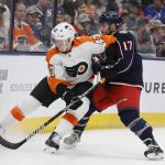 
              Philadelphia Flyers' Ronnie Attard, left, and Columbus Blue Jackets' Justin Danforth fight for a loose puck during the second period of an NHL hockey game Thursday, April 7, 2022, in Columbus, Ohio. (AP Photo/Jay LaPrete)
            