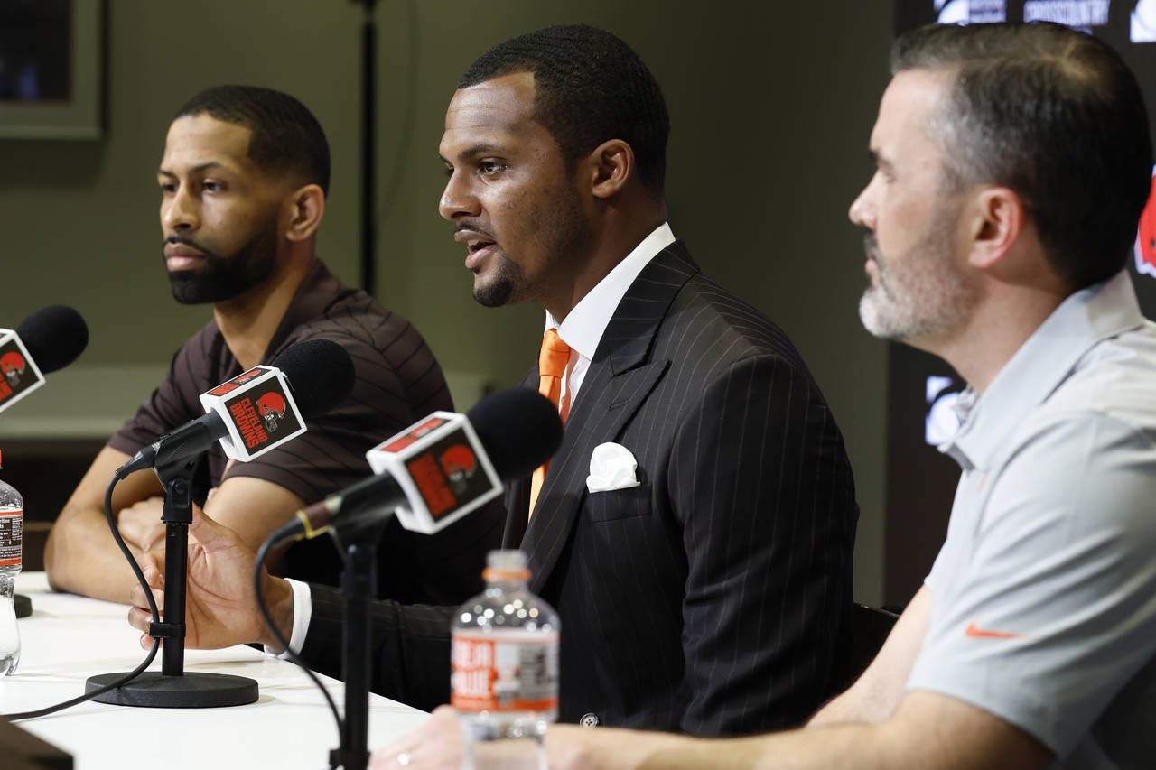Cleveland Browns new quarterback Deshaun Watson, center, speaks during a news conference at the NFL...