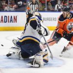 
              St. Louis Blues goalie Ville Husso (35) makes a save on Edmonton Oilers' Jesse Puljujarvi (13) during the second period of an NHL hockey game Friday, April 1, 2022, in Edmonton, Alberta. (Jason Franson/The Canadian Press via AP)
            