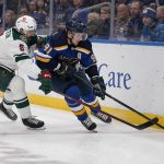 
              St. Louis Blues' Vladimir Tarasenko (91) handles the puck as Minnesota Wild's Jacob Middleton (5) defends during the second period of an NHL hockey game Friday, April 8, 2022, in St. Louis. (AP Photo/Jeff Roberson)
            