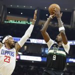 
              Milwaukee Bucks' Bobby Portis puts up a shot in front of Los Angeles Clippers' Robert Covington during the first half of an NBA basketball game Friday, April 1, 2022, in Milwaukee. (AP Photo/Jeffrey Phelps)
            