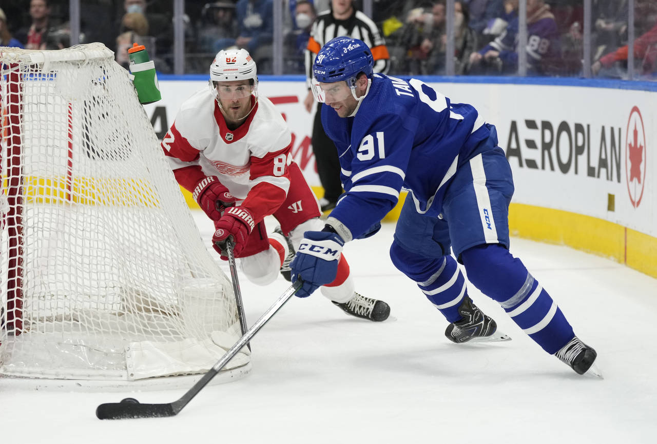 Toronto Maple Leafs center John Tavares (91) carries the puck around the side of the Detroit Red Wi...