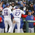 
              Chicago Cubs' Seiya Suzuki (27) is congratulated by manager David Ross, right, after scoring against the Milwaukee Brewers during the fifth inning of a baseball game, Thursday, April 7, 2022, in Chicago. (AP Photo/Kamil Krzaczynski)
            