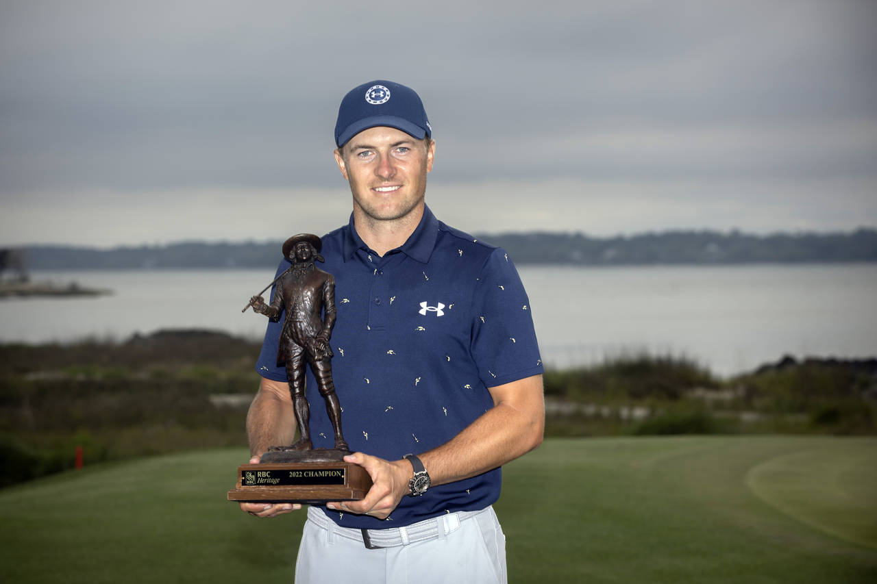 Jordan Spieth holds the championship trophy after winning a one-hole playoff at the RBC Heritage go...