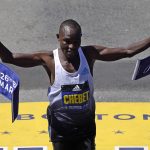 
              Evans Chebet, of Kenya, breaks the tape to win the Boston Marathon, Monday, April 18, 2022, in Boston. (AP Photo/Charles Krupa)
            
