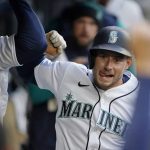 
              Seattle Mariners' Jarred Kelenic is greeted in the dugout after hitting a solo home run against the Texas Rangers during the second inning of a baseball game Tuesday, April 19, 2022, in Seattle. (AP Photo/Ted S. Warren)
            