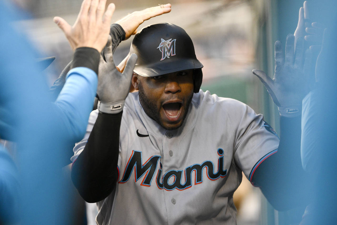 Miami Marlins' Jesus Aguilar celebrates his home run in the dugout during the third inning of a bas...