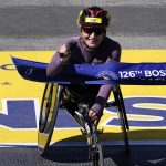 
              Manuela Schar, of Switzerland, breaks the tape to win the women's wheelchair division of the Boston Marathon, Monday, April 18, 2022, in Boston. (AP Photo/Charles Krupa)
            