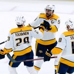 
              Nashville Predators right wing Eeli Tolvanen (28) celebrates his goal against the Arizona Coyotes with center Colton Sissons (10) and defenseman Roman Josi (59) during the first period of an NHL hockey game Friday, April 29, 2022, in Glendale, Ariz. (AP Photo/Ross D. Franklin)
            