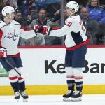 
              Washington Capitals right wing Garnet Hathaway (21) celebrates a goal against the Colorado Avalanche with teammate Lars Eller (20) during the first period of an NHL hockey game Monday, April 18, 2022, in Denver. (AP Photo/Jack Dempsey)
            